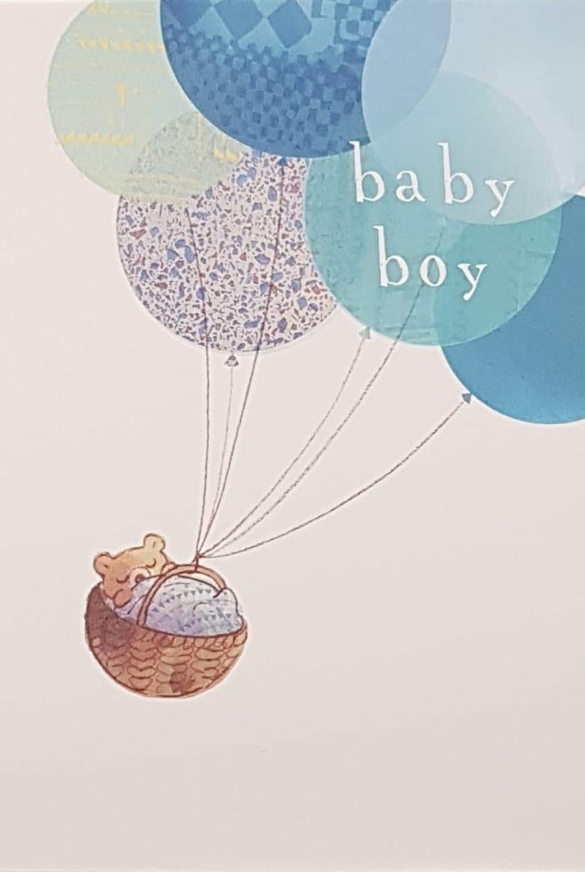 New Baby Card - Boy / Bunch Of Blue Balloons Flying & Holding A Basket With A Sleeping Teddy