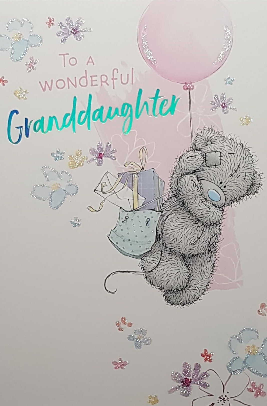 Birthday Card - Granddaughter / Teddy Bear Floating By A Balloon Holding A Bag With A Gift