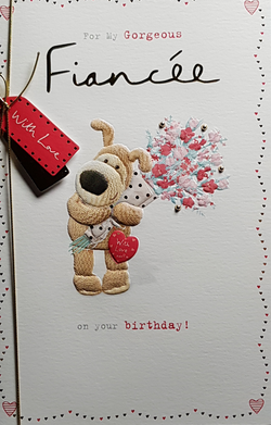 Birthday Card - Fiancee / A Cute Dog Holding Pink Flowers & A Gold Ribbon